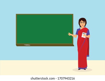 Indian woman teacher in saree in front of a green board