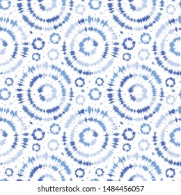 Indigo blue shibori tie dye sunburst circle background. Seamless pattern on white background. Japanese style batik textile. Variegated for summer fashion swatch.
 