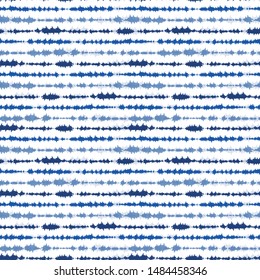 Indigo blue shibori tie dye horizontal stripe. Seamless pattern background. Japanese style batik textile. Variegated for summer fashion swatch.