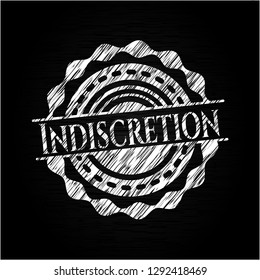 Indiscretion chalk emblem written on a blackboard