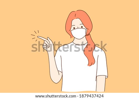 Individual protection from COVID-19 and gesturing concept. Young woman cartoon character in medical protective mask from coronavirus disease pointing with hand and finger up to side