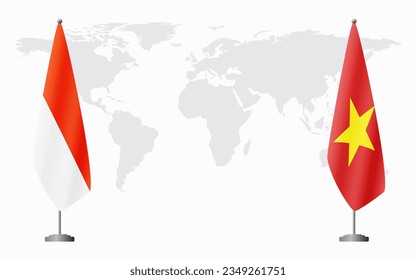 Indonesia and Vietnam flags for official meeting against background of world map.