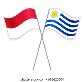 Indonesian and Uruguayan crossed flags. Indonesia combined with Uruguay isolated on white. Language learning, international business or travel concept.