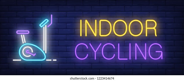 Indoor cycling neon sign. Glowing inscription with exercise bike on brick wall background. Vector illustration can be used for fitness clubs, sports, trainings