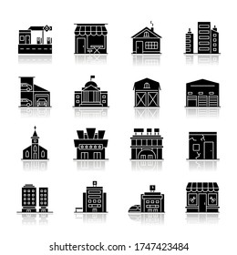 Industrial buildings drop shadow black glyph icons set. High rise skyscrapers. Car parking. Cinema theater. Urban district. City constructions. Isolated vector illustrations on white space
