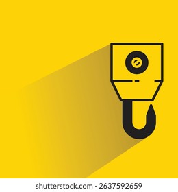industrial crane hook icon with drop shadow on yellow background