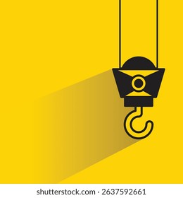 industrial crane hook icon with drop shadow on yellow background