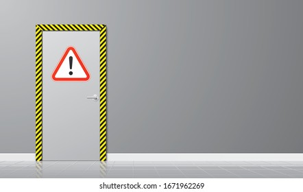 Industrial door with a triangle caution sign and striped yellow frame on a grey wall background. Restricted area with hazard warning icon. Safety horizontal background.