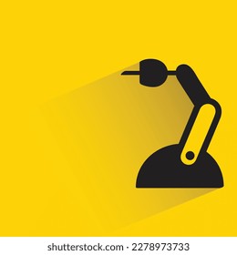 industrial robotic arm with shadow on yellow background