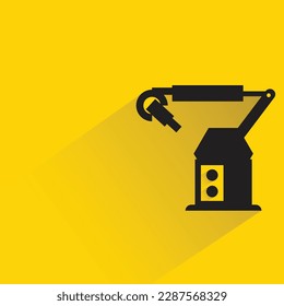 industrial robotic arm with shadow on yellow background
