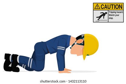 An industrial worker is crawling on the floor.
