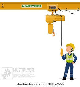 An industrial worker is operating electric chain hoist
