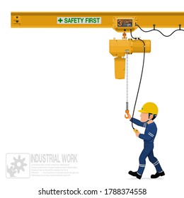 An industrial worker is operating electric chain hoist
