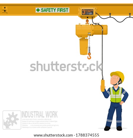 An industrial worker is operating electric chain hoist
