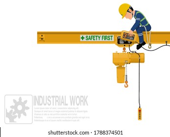 An industrial worker is repairing electric chain hoist
