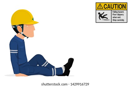 An industrial worker is sitting on the floor
