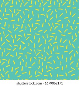 Infinite vector pattern of yellow specks on green background