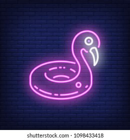 Inflatable flamingo neon sign. Big pink swimming pool toy on dark brick wall background. Night bright advertisement. Vector illustration in neon style for resort or summer vacation