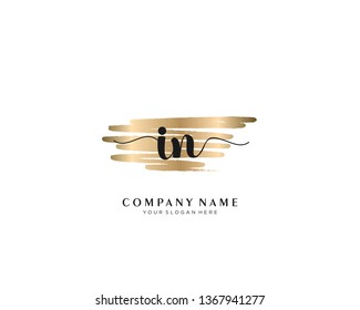 IN initial handwriting logo with brush gold color template vector