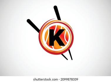 Initial K monogram alphabet in the abstract circle with Chopstick. Abstract Asian sushi bar emblem. Logo for Japanese sushi seafood business and company identity