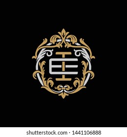 Initial letter E and I, EI, IE, decorative ornament emblem badge, overlapping monogram logo, elegant luxury silver gold color on black background