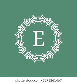 initial letter E ornamental futuristic circle pattern frame emblem logo