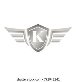 initial letter K shield logo with wings vector illustration