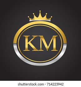 initial letter KM logotype company name with oval shape and crown, gold and silver color. vector logo for business and company identity.