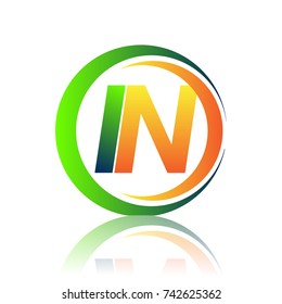 initial letter logo IN company name green and orange color on circle and swoosh design. vector logotype for business and company identity.