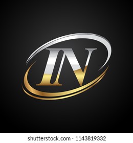 initial letter IN logotype company name colored gold and silver swoosh design. isolated on black background.
