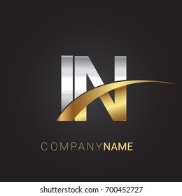 initial letter IN logotype company name colored gold and silver swoosh design. isolated on black background.