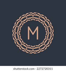 initial letter M ornamental emblem frame circle pattern logo