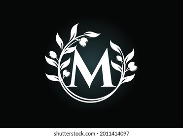 Initial letter M sign symbol with olive branch wreath. Round floral frame made by the olive branch. Agriculture industry logo design vector template. Olive oil label