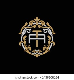 Initial letter A and T, AT, TA, decorative ornament emblem badge, overlapping monogram logo, elegant luxury silver gold color on black background