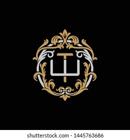 Initial letter W and T, WT, TW, decorative ornament emblem badge, overlapping monogram logo, elegant luxury silver gold color on black background