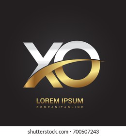 initial letter XO logotype company name colored gold and silver swoosh design. isolated on black background.