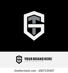 Initial letters G, T, GT or TG overlapping, interlocked monogram logo, white and gray color on black background