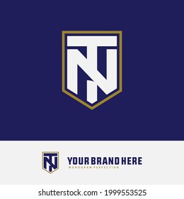 Initial letters N, T, NT or TN overlapping, interlocked monogram logo, white and gold color on blue background