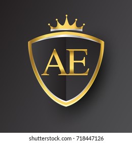 Initial logo letter AE with shield and crown Icon golden color isolated on black background, logotype design for company identity.