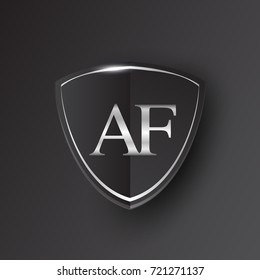 Initial logo letter AF with shield Icon silver color isolated on black background, logotype design for company identity.