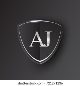 Initial logo letter AJ with shield Icon silver color isolated on black background, logotype design for company identity.