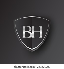 Initial logo letter BH with shield Icon silver color isolated on black background, logotype design for company identity.