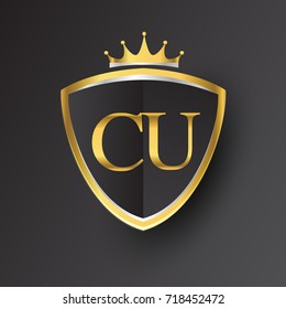 Initial logo letter CU with shield and crown Icon golden color isolated on black background, logotype design for company identity.
