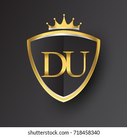 Initial logo letter DU with shield and crown Icon golden color isolated on black background, logotype design for company identity.