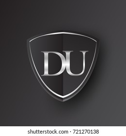 Initial logo letter DU with shield Icon silver color isolated on black background, logotype design for company identity.