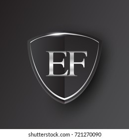 Initial logo letter EF with shield Icon silver color isolated on black background, logotype design for company identity.