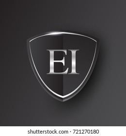 Initial logo letter EI with shield Icon silver color isolated on black background, logotype design for company identity.