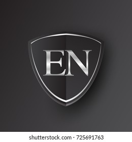 Initial logo letter EN with shield Icon silver color isolated on black background, logotype design for company identity.