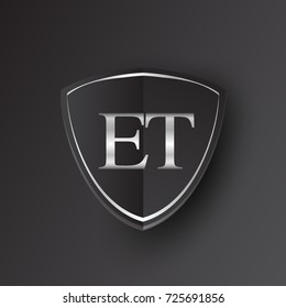 Initial logo letter ET with shield Icon silver color isolated on black background, logotype design for company identity