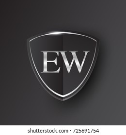 Initial logo letter EW with shield Icon silver color isolated on black background, logotype design for company identity.